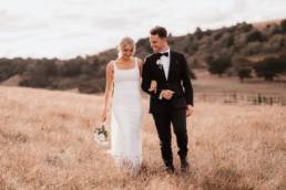 Vellela and Michael in their classic wedding attire on the hilltop of McGrath Estate.