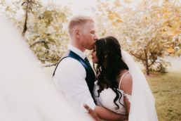 Trisha Darcy kiss in the vineyard at Markovina Vineyard Estate in Kumeu